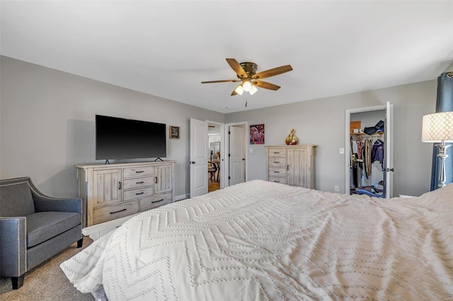 carpeted bedroom featuring a closet, ceiling fan, and a spacious closet