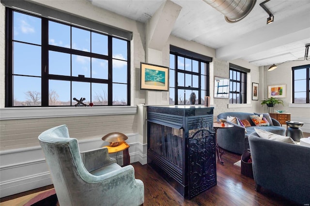 interior space with wood finished floors and beam ceiling