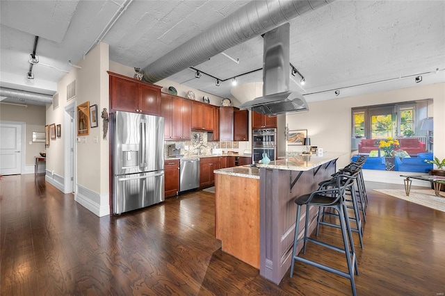 kitchen with a breakfast bar, dark wood finished floors, appliances with stainless steel finishes, tasteful backsplash, and island exhaust hood