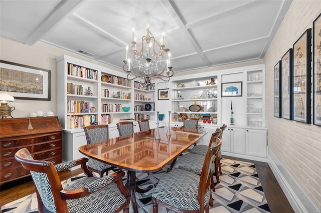 dining space featuring visible vents, coffered ceiling, wood finished floors, beamed ceiling, and a notable chandelier