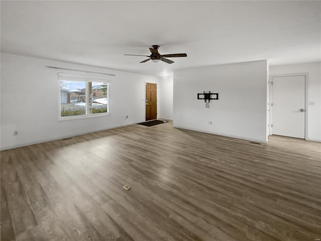 unfurnished living room with ceiling fan and wood finished floors