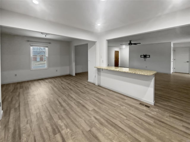 interior space featuring ceiling fan, recessed lighting, wood finished floors, and baseboards