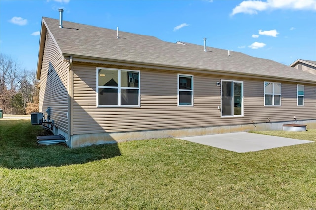 rear view of house with central air condition unit, a patio area, roof with shingles, and a yard