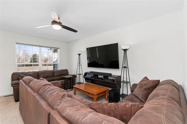 living room with light carpet, ceiling fan, visible vents, and baseboards