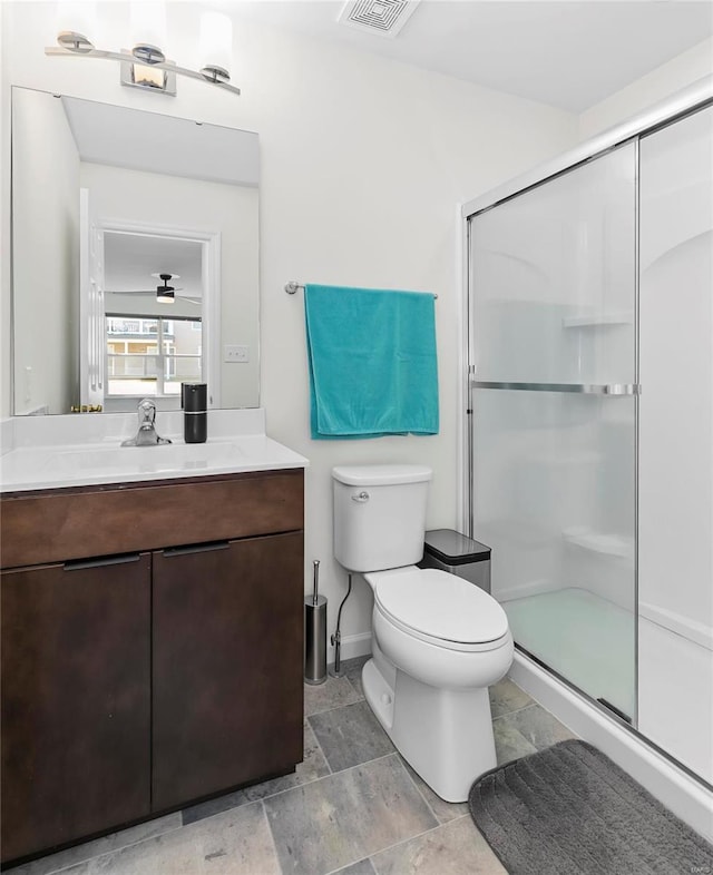 full bathroom with toilet, visible vents, a stall shower, and vanity