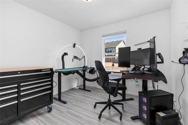 home office featuring baseboards and wood finished floors