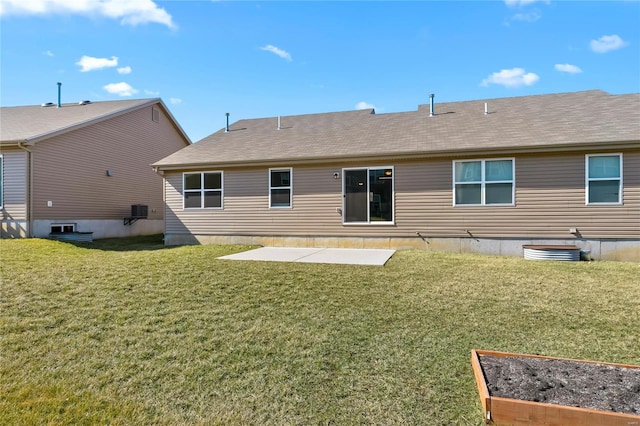 rear view of property with a shingled roof, a vegetable garden, a yard, and a patio