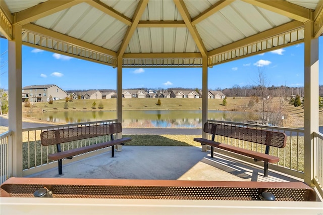 view of patio / terrace featuring a water view, a residential view, and a gazebo