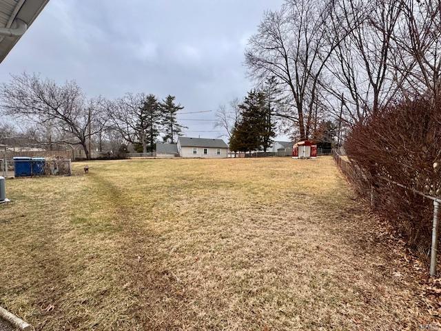 view of yard featuring an outbuilding and a shed