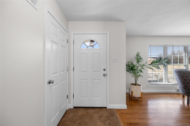 foyer with wood finished floors and baseboards