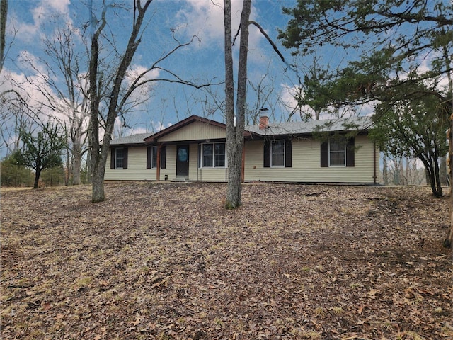 ranch-style house featuring a chimney