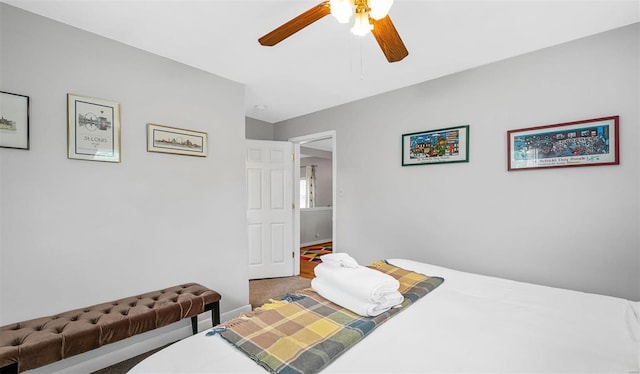 carpeted bedroom featuring ceiling fan and baseboards