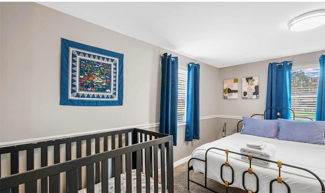 carpeted bedroom featuring baseboards