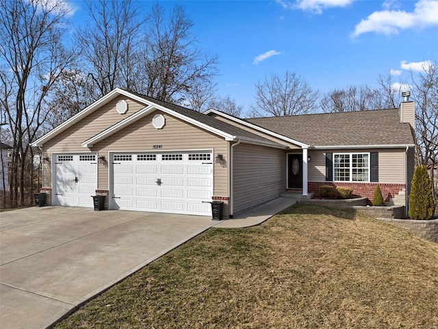 ranch-style home with concrete driveway, a chimney, an attached garage, a front lawn, and brick siding