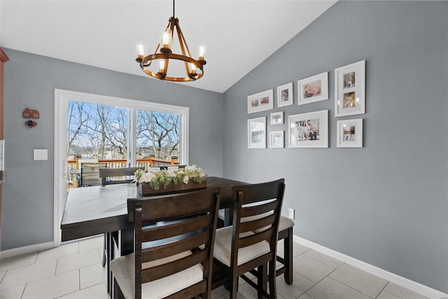 dining area with vaulted ceiling, light tile patterned flooring, baseboards, and a notable chandelier