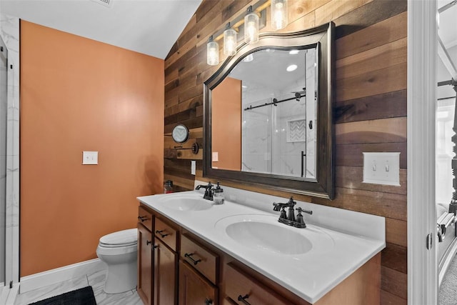 full bath featuring lofted ceiling, wood walls, marble finish floor, and a sink