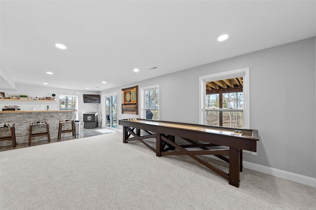 recreation room with recessed lighting, visible vents, carpet flooring, brick wall, and baseboards