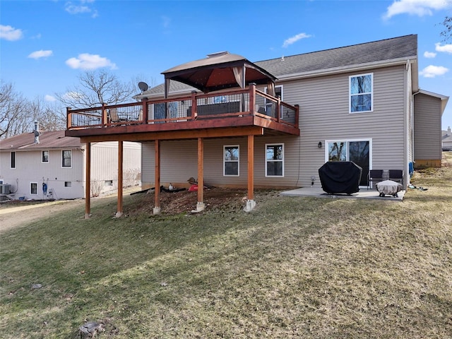 rear view of house featuring central air condition unit, a yard, a deck, and a patio