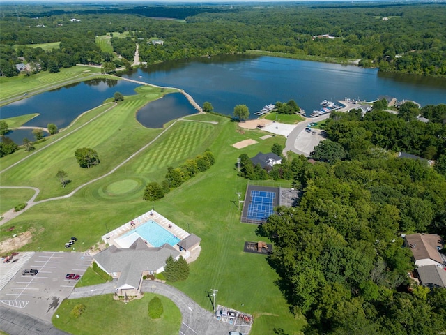 aerial view with a water view and a forest view