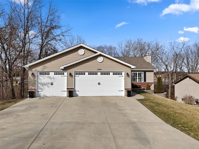 view of front facade featuring driveway, a chimney, an attached garage, a front lawn, and brick siding