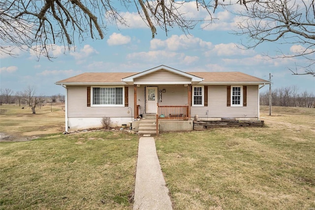 view of front of property with a porch, a front lawn, and a shingled roof