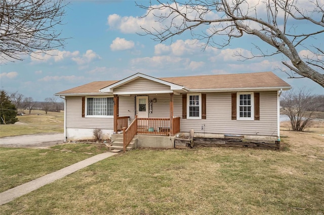 view of front of property featuring a porch, a front yard, and a shingled roof