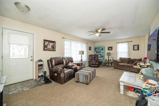 living room featuring carpet floors and ceiling fan