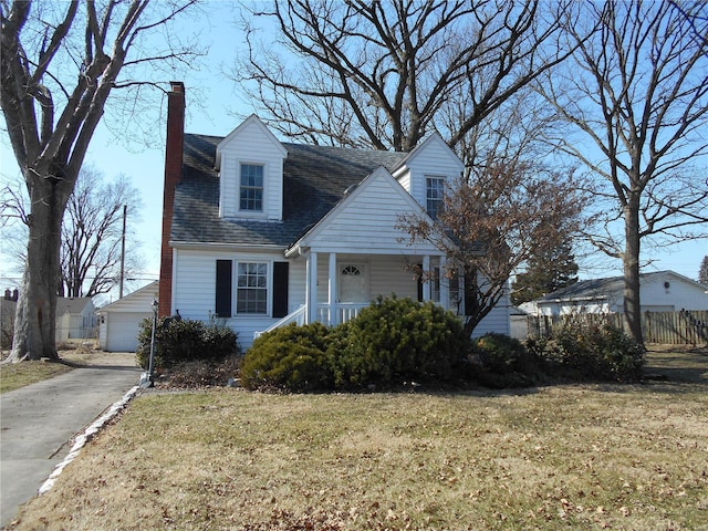 cape cod house featuring roof with shingles, fence, an outdoor structure, a front lawn, and a porch