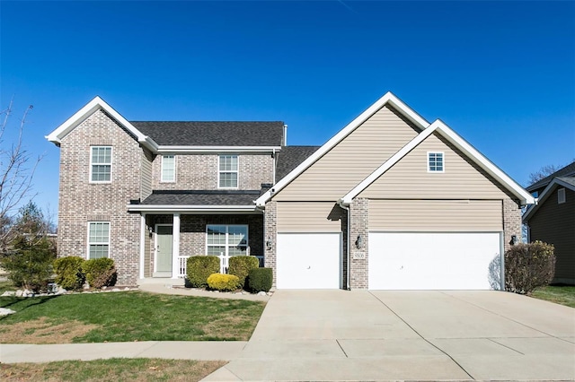 traditional-style house with a garage, a front yard, brick siding, and driveway