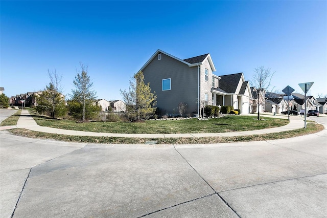 view of home's exterior featuring a residential view and a lawn