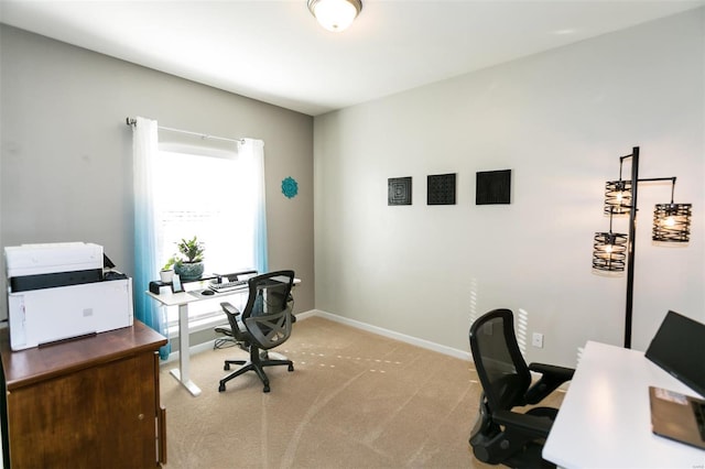 home office featuring baseboards and light colored carpet