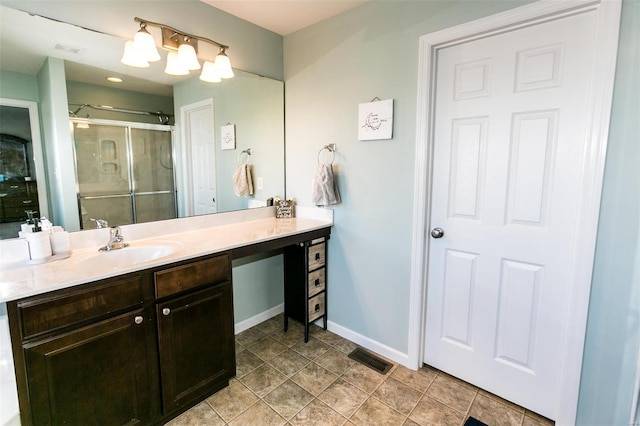 bathroom featuring a stall shower, visible vents, baseboards, and vanity