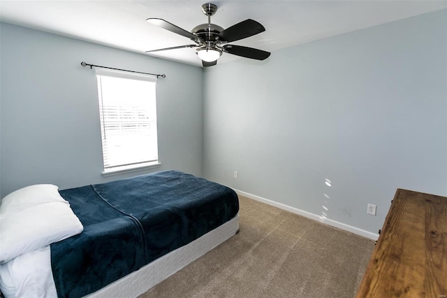 bedroom with ceiling fan, carpet flooring, and baseboards