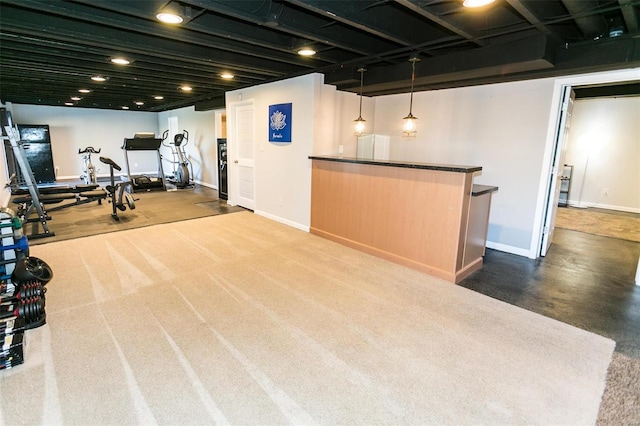 exercise room featuring a bar and baseboards