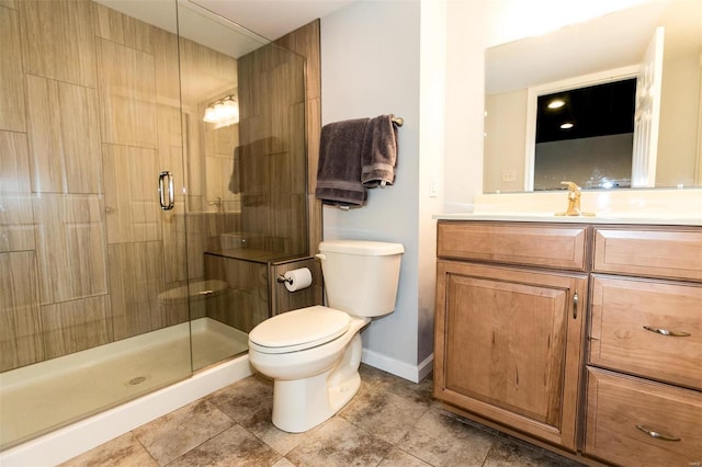 full bath with a stall shower, vanity, toilet, and baseboards