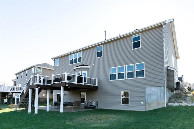 back of property featuring a yard, stairway, a deck, and a patio