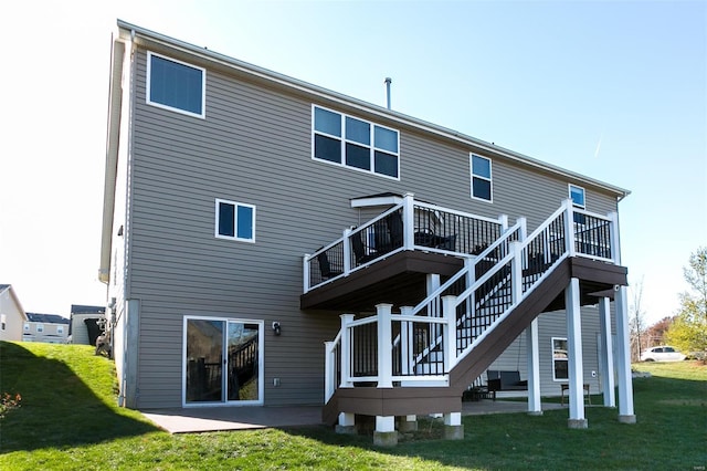 back of house with stairs, a patio, a deck, and a lawn