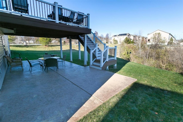 view of patio featuring outdoor dining area, stairway, and a wooden deck