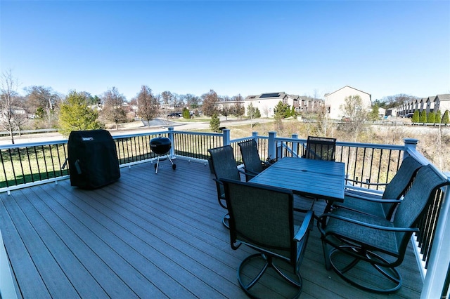 deck featuring a residential view and outdoor dining space