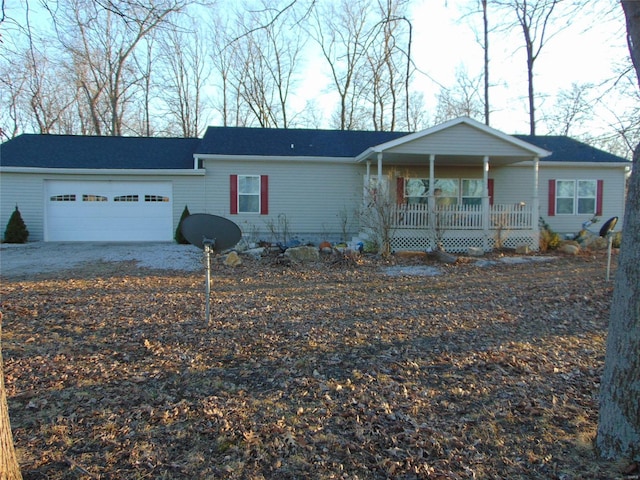 ranch-style house featuring a garage and a porch