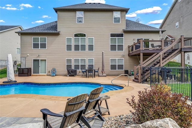 view of pool with stairway, a patio area, a deck, and fence