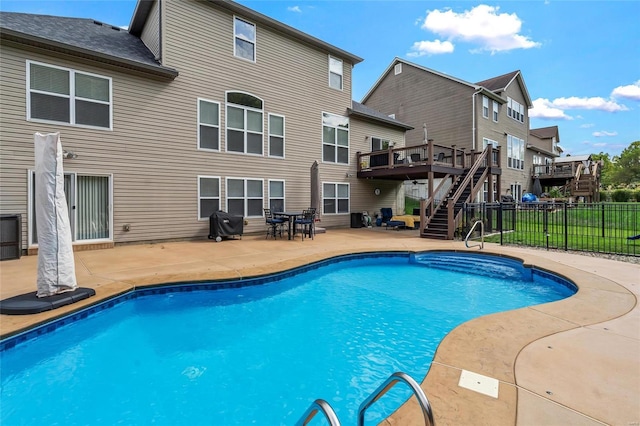 view of swimming pool with a fenced in pool, fence, a wooden deck, stairs, and a patio