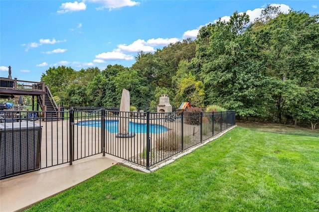 community pool with fence, stairs, a deck, a yard, and a patio area