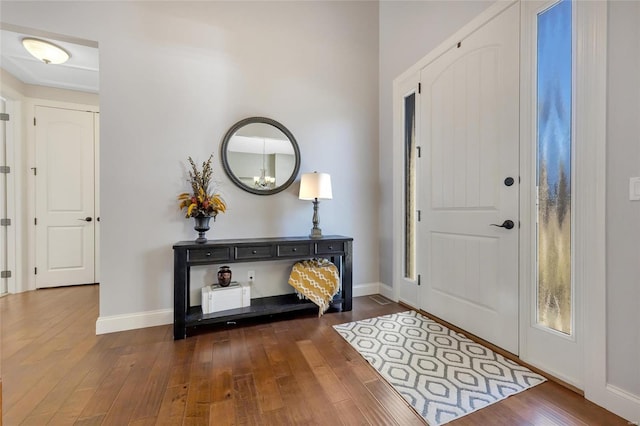 entrance foyer with dark wood finished floors and baseboards