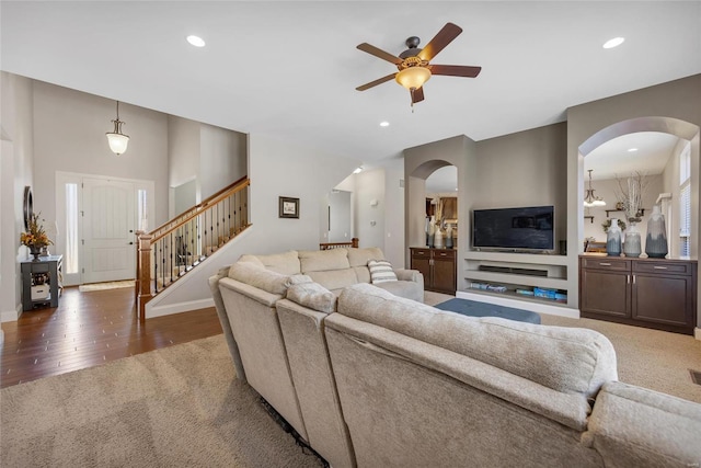 living area featuring wood finished floors, stairway, recessed lighting, and baseboards