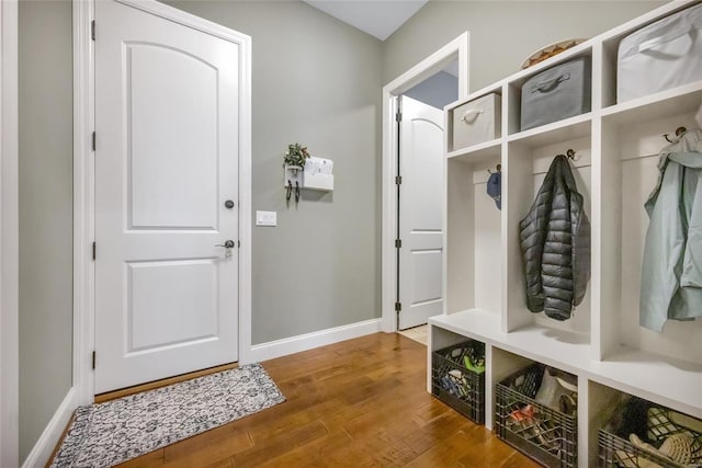 mudroom with wood finished floors and baseboards