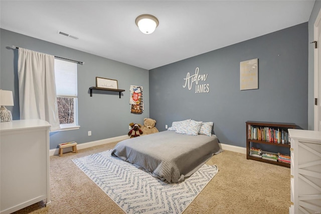 carpeted bedroom featuring visible vents and baseboards