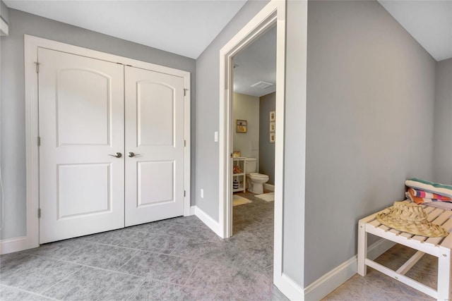 bedroom with a closet and baseboards