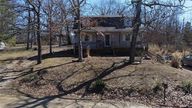 view of front of property featuring covered porch and stairway