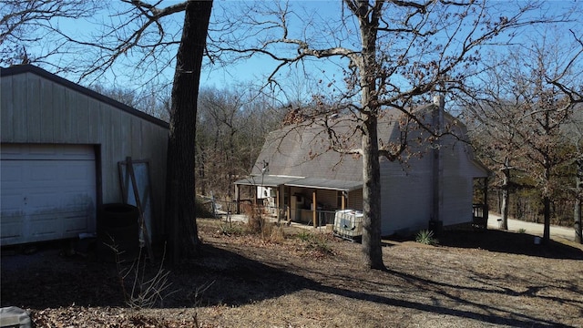 exterior space with a porch and an outdoor structure